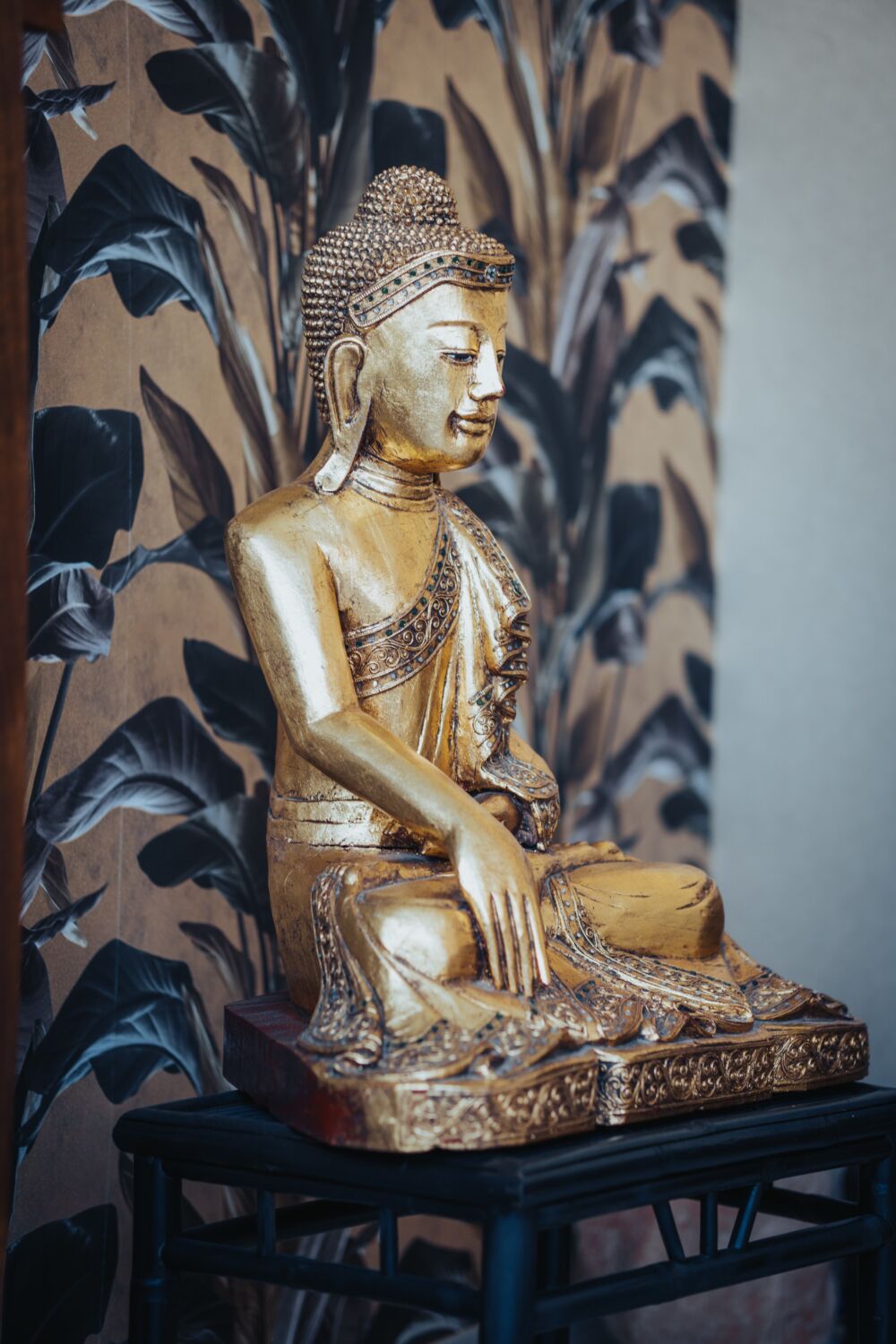 Nahaufnahme einer goldenen Buddhafigur in der Physiotherapiepraxis